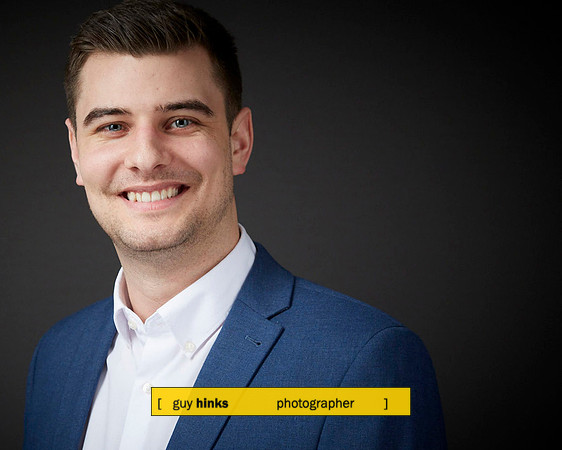 Headshot of senior staff against grey background - photographed in their office in Glasgow.
